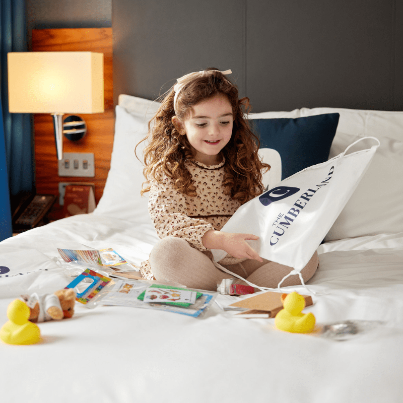 Girl playing on bed at Cumberland