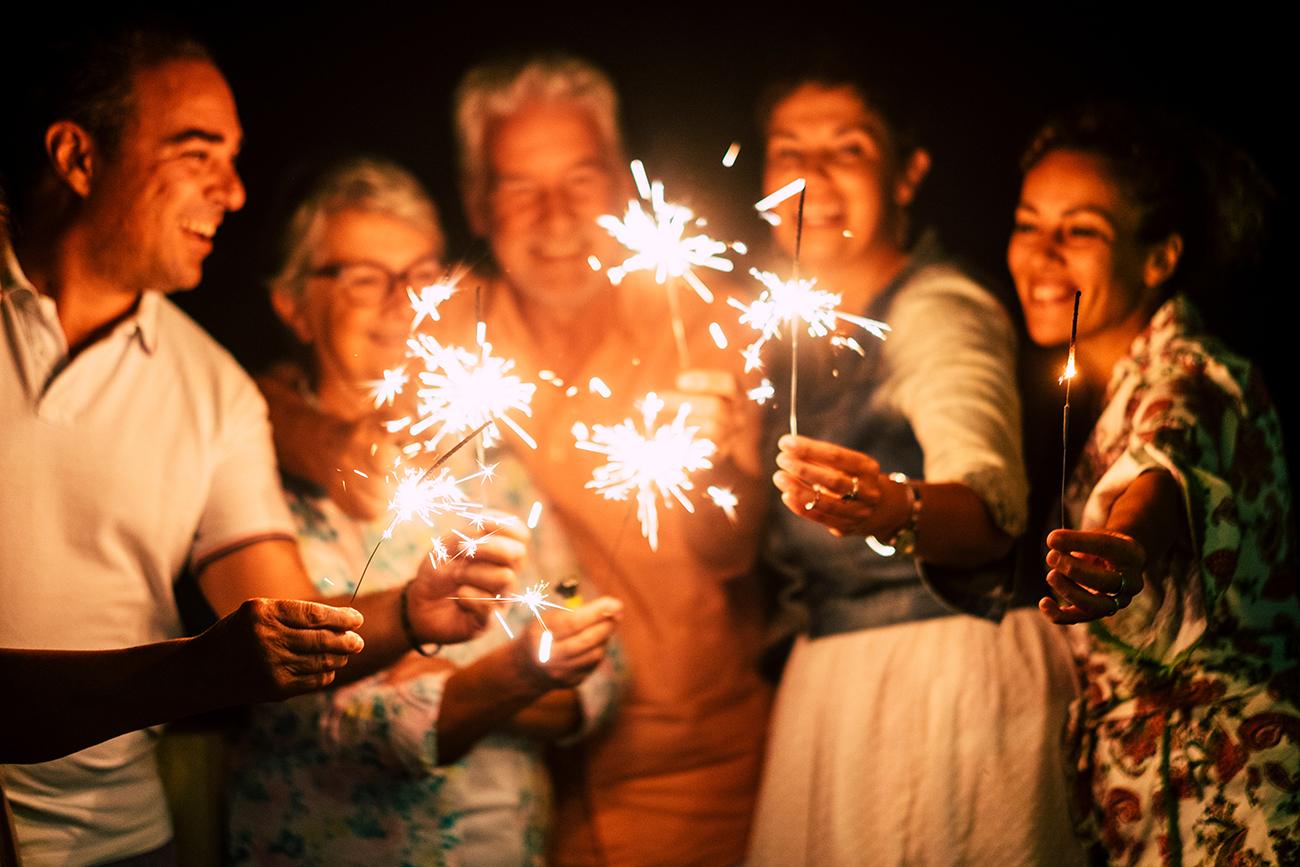 Three generations of a family holding sparklers