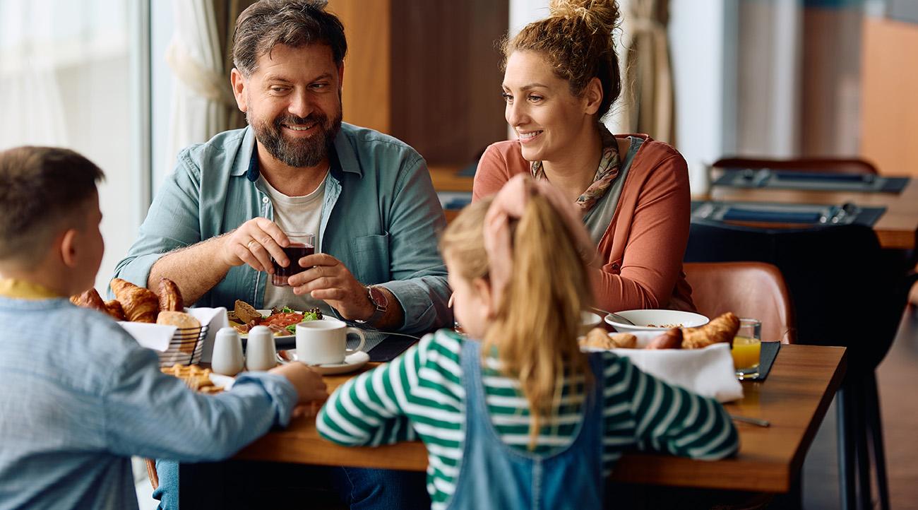 Happy parents enjoying in breakfast time with their kids at The Cumberland Hotel