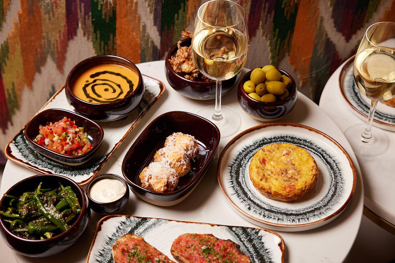 A picture of lots of plates of delicious food taken from above